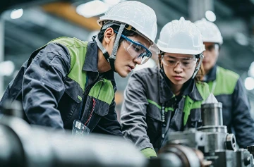 Workers Manufacturing Machinery In Workshop